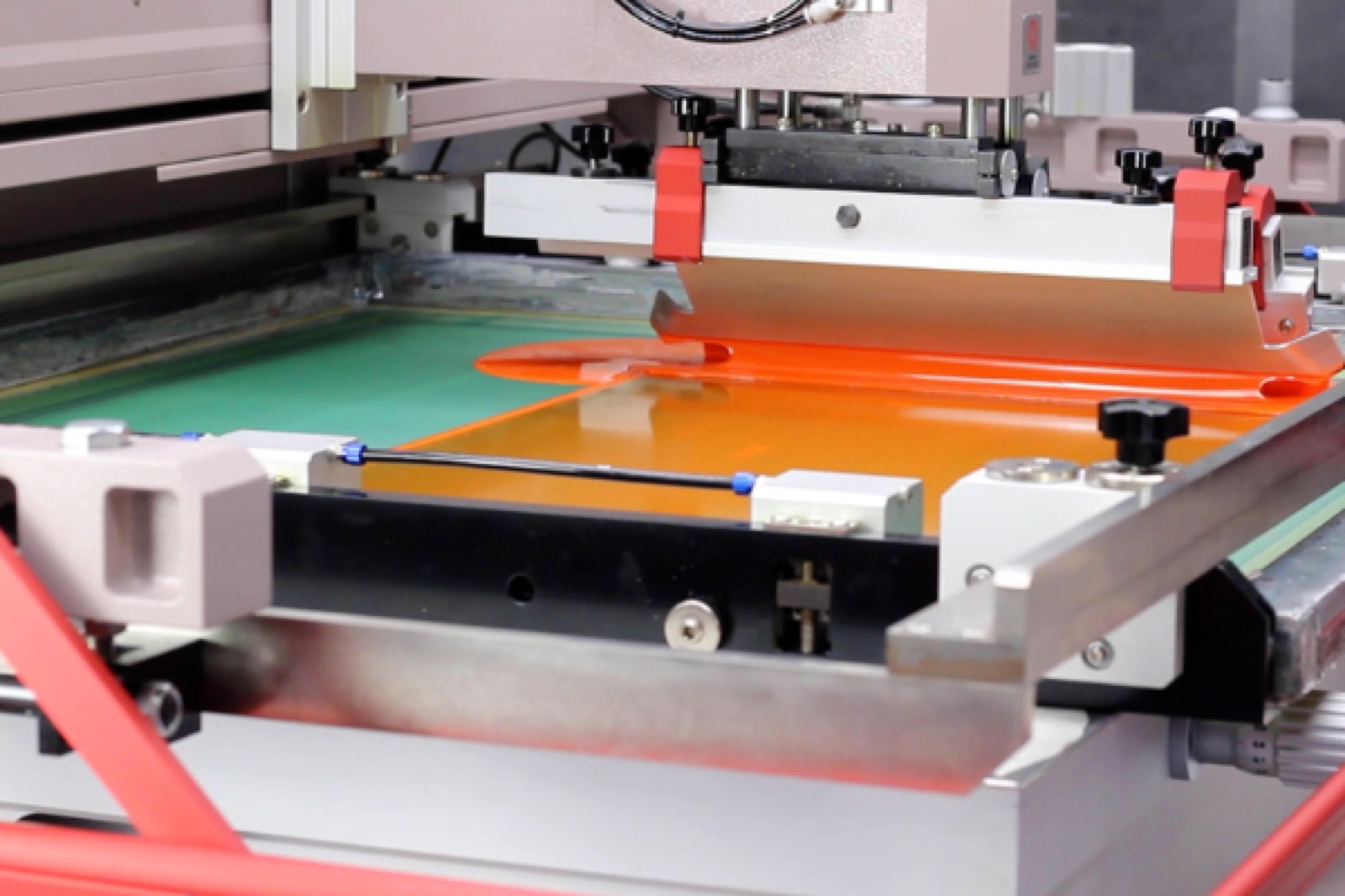 Screen printing station showing thick ink deposit